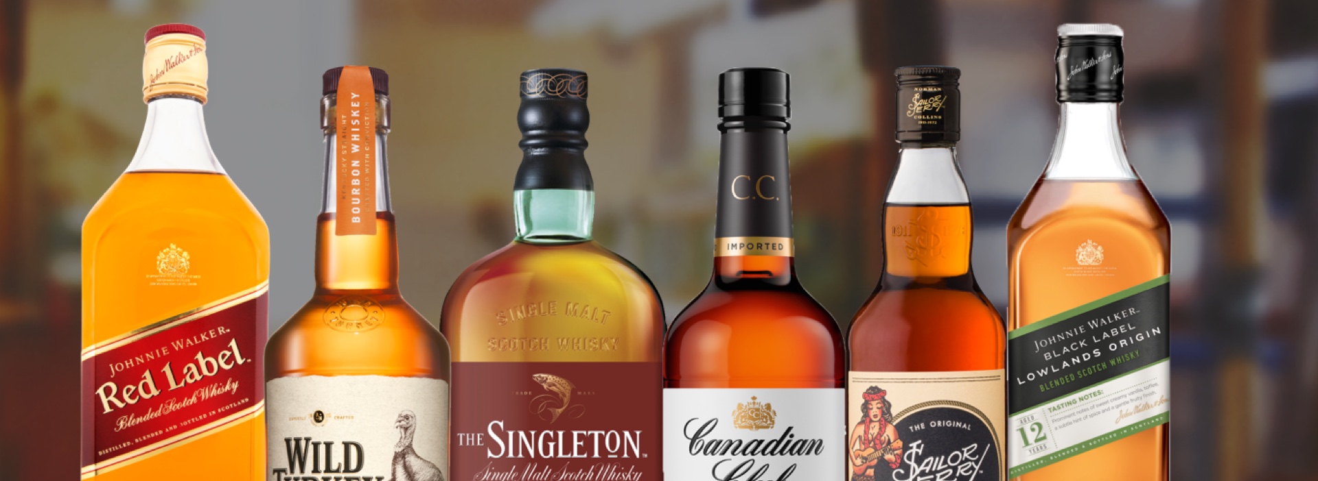 Close-up six different branded bottles of whisky 