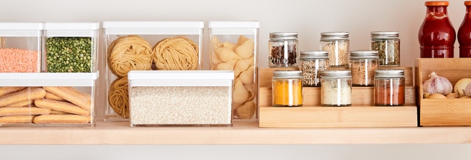 Shop Kmart Organised bright wooden kitchen shelf with containers holding spices, biscuits and sauces