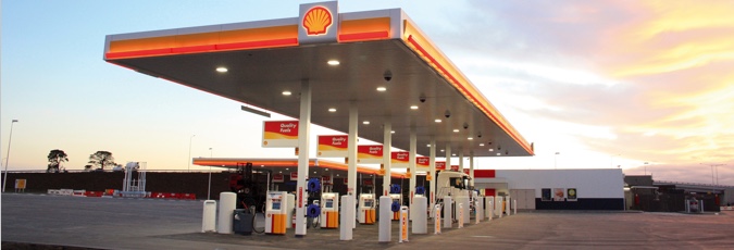 Points with Shell Coles Express Bright skyline with Shell branded petrol station and multiple fuel pumps in a line
