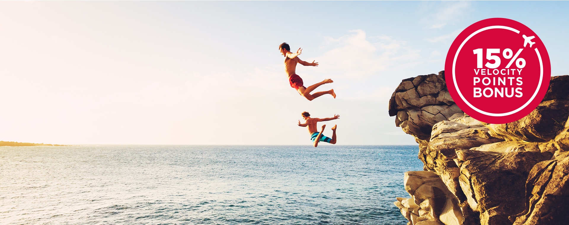 Kids jumping off a rock into the ocean with a 15% Velocity points bonus icon over the top