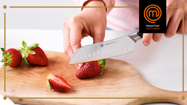 Close up of someone cutting Strawberries with a MasterChef Knife