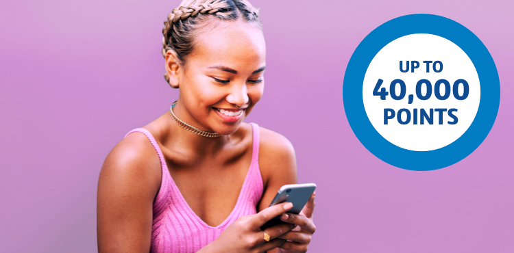 Girl looking at phone with an Up to 40,000 points ring to the left