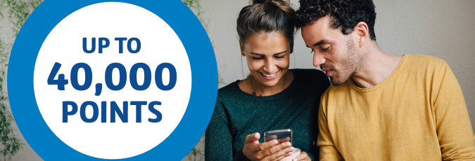 Optus Girl and guy looking at a phone being held by the girl, with an Up to 40,000 points ring on the left