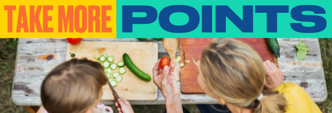 Get healthy and points wealthy with HCF Text reads: "Take More Points", image features a woman and a boy cutting vegetables on an outdoor table