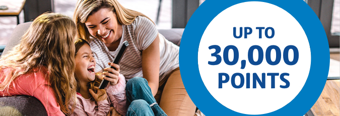 Enjoy fast and reliable nbn A blonde haired family share a laugh over a mobile device with roundel stating "Up to 30,000 points"