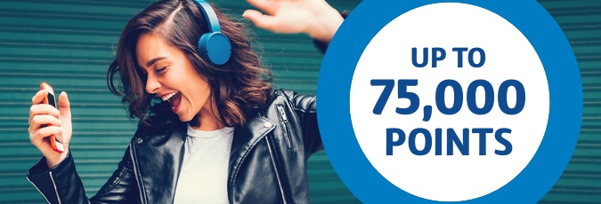 Exclusive Optus Flybuys offer Young woman with blue headphones and a black leather jacket dancing with arms in the air.