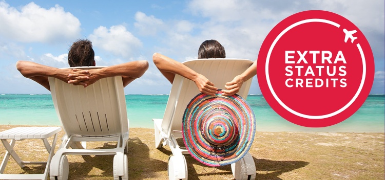 Two holidaymakers reclined in deck chairs on the beach