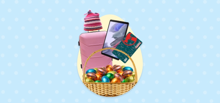 Blue spotted background with woven basket filled with colourful foil Easter eggs, $50 Bunnings Warehouse gift card, iPad and pink beanie atop of pink suitcase