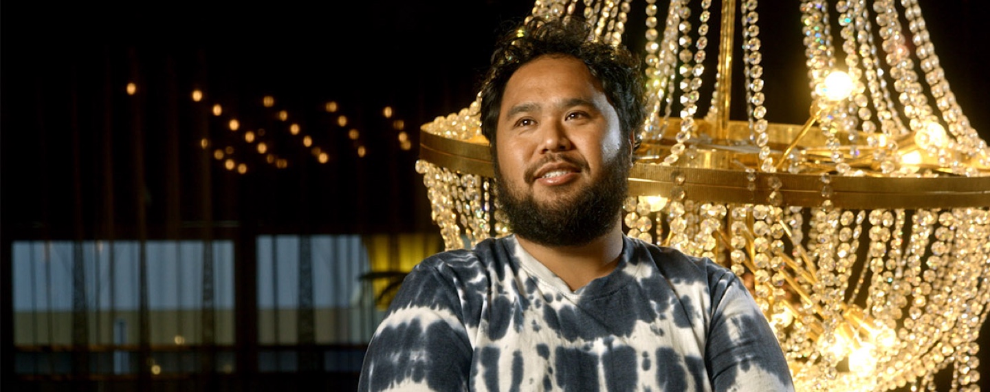 Flybuys' top 10 members Moris next to chandelier 
