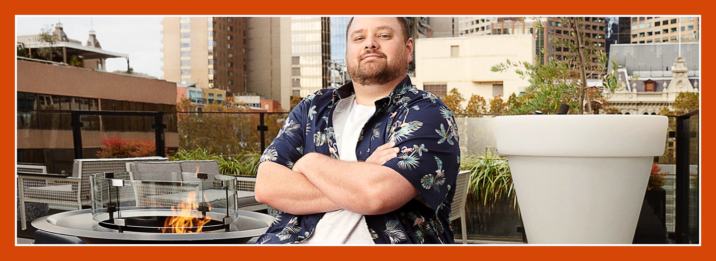 Flybuys' top 10 member Dale sitting next to firepit with arms crossed