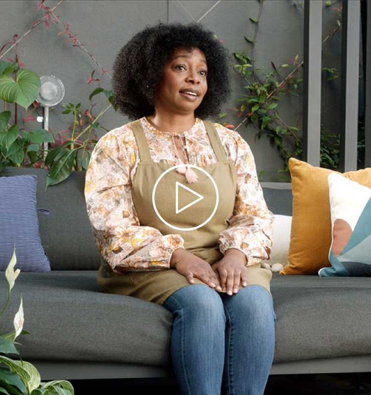 Flybuys' top 10 member Megan sitting on the couch speaking