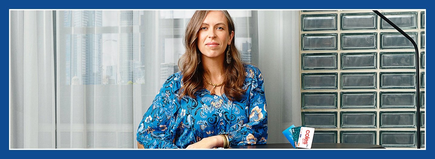Flybuys' top 10 member Melanie sitting next to Officeworks, Bunnings and Coles gift cards
