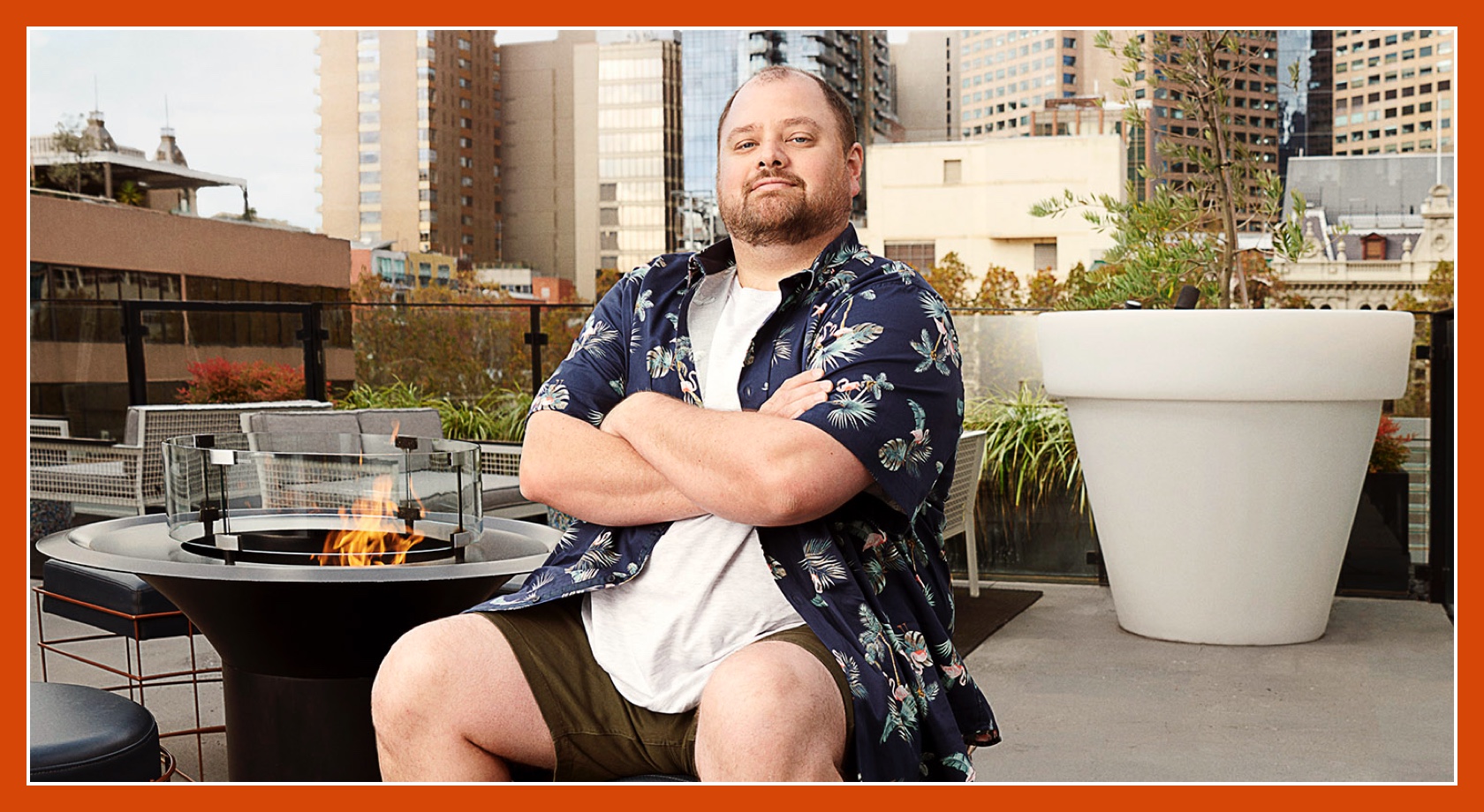 Flybuys' top 10 member Dale sitting next to firepit with arms crossed