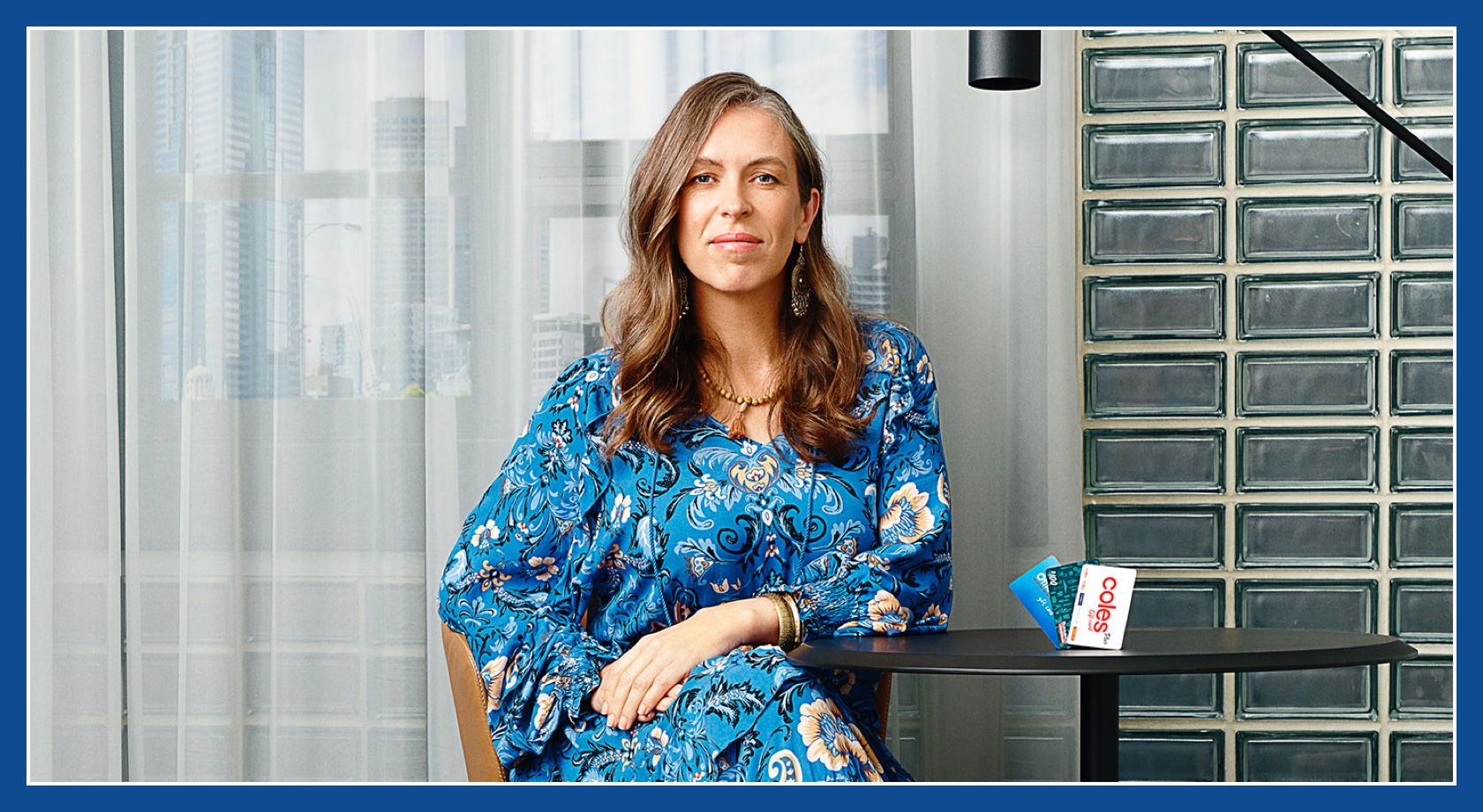 Flybuys' top 10 member Melanie sitting next to Officeworks, Bunnings and Coles gift cards