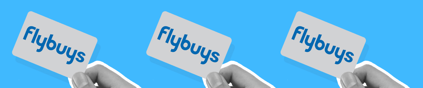 Hands holding Flybuys cards