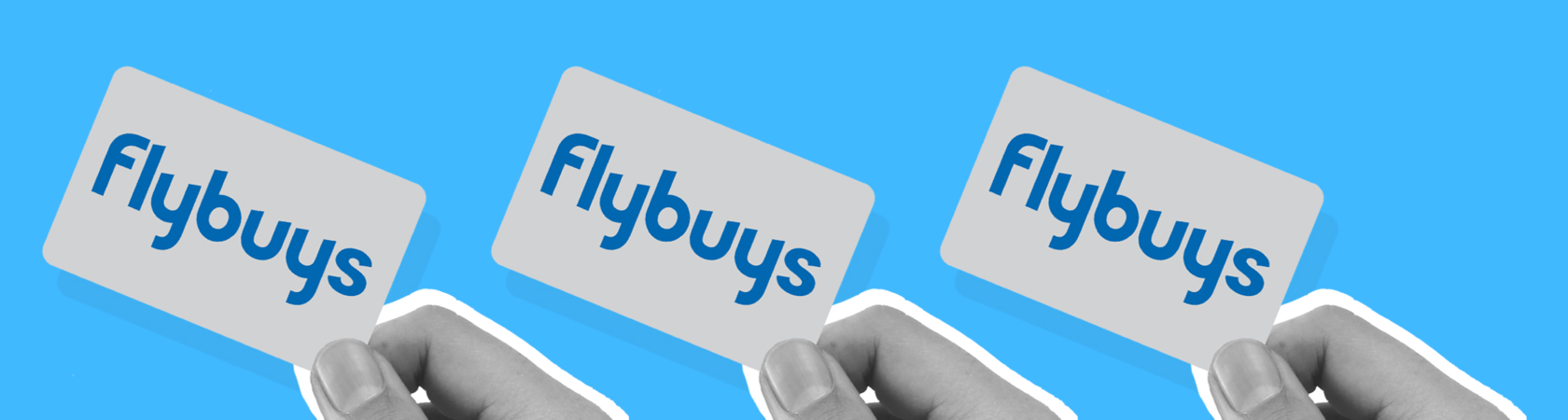 Hands holding Flybuys cards