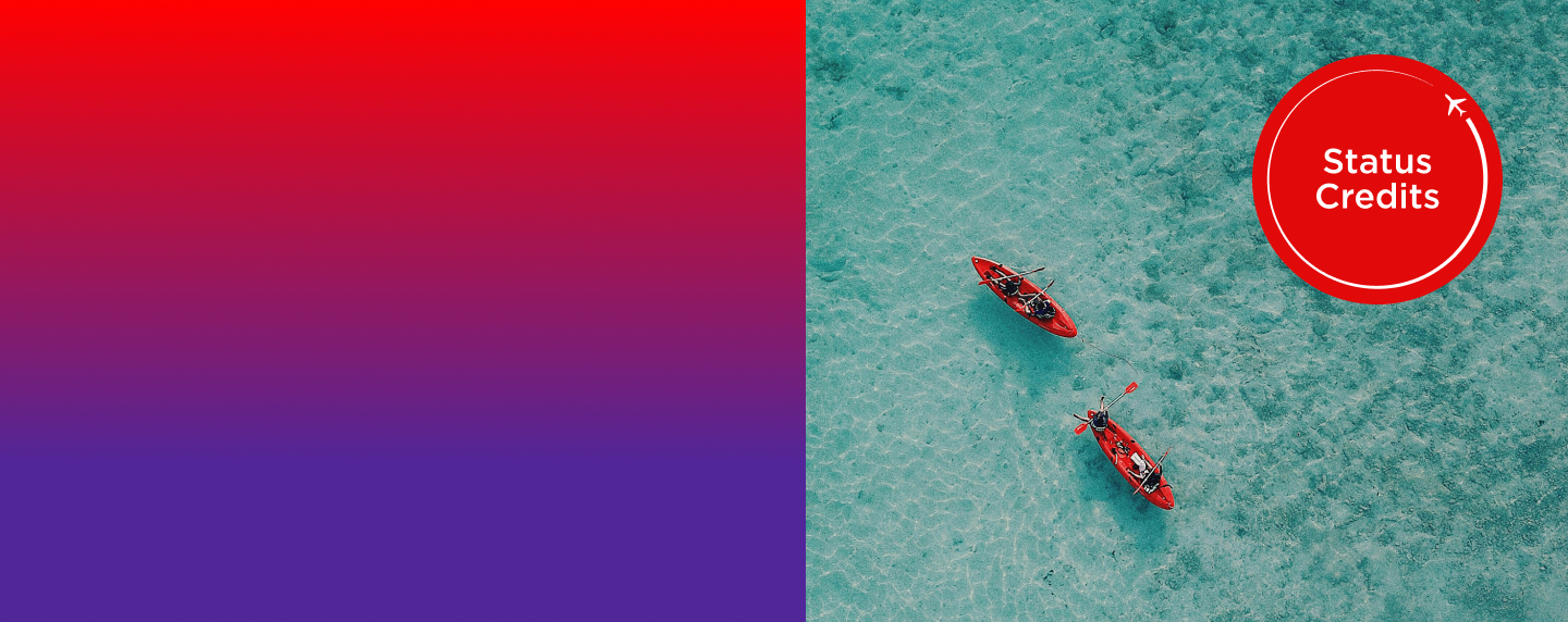 Two red canoes out in ocean by status credits roundel