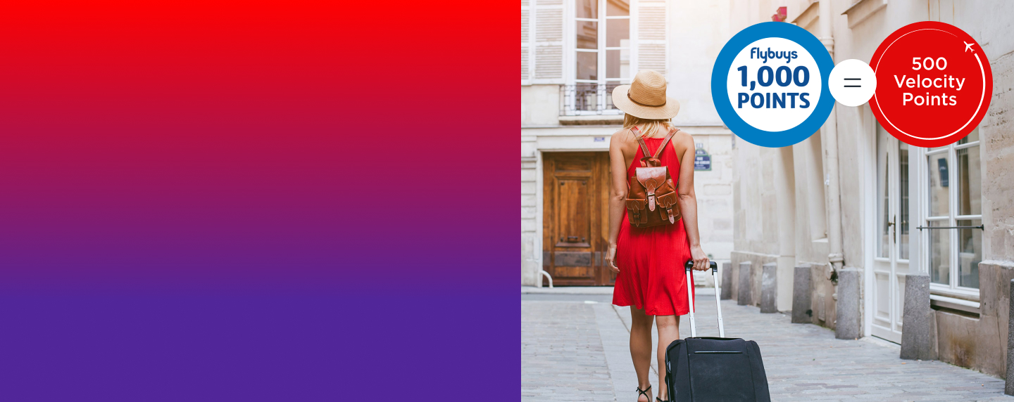 women pulling luggage behind her by Flybuys 1,000 points roundel = 500 Velocity points roundel