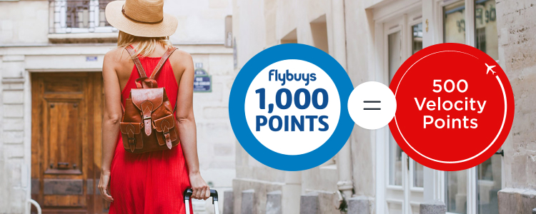 women pulling luggage behind her by Flybuys 1,000 points roundel = 500 Velocity points roundel