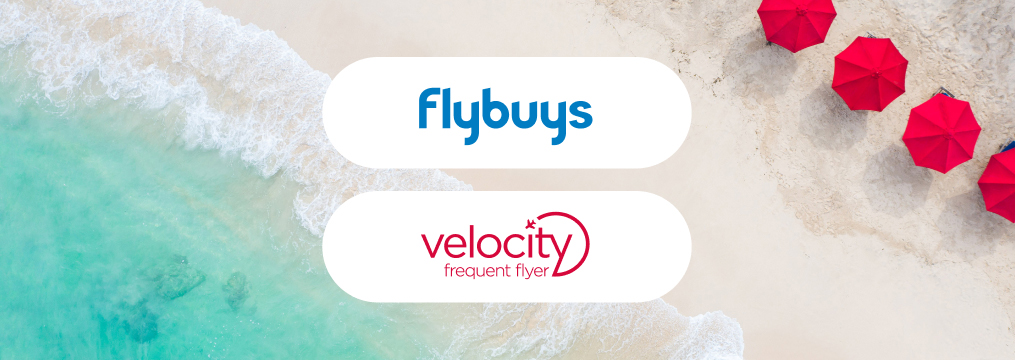 Fly faster with Flybuys and Velocity Flybuys and velocity frequent flyer logos on beach front with red umbrellas