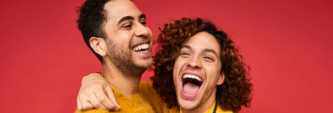 Smiling couple with arms wrapped around each other