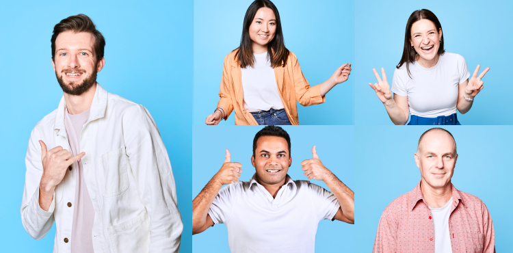 Excited employees standing in front of a blue background