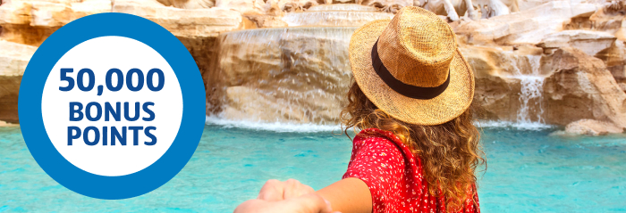 Tourist viewing the Trevi Fountain and 50,000 bonus points roundel