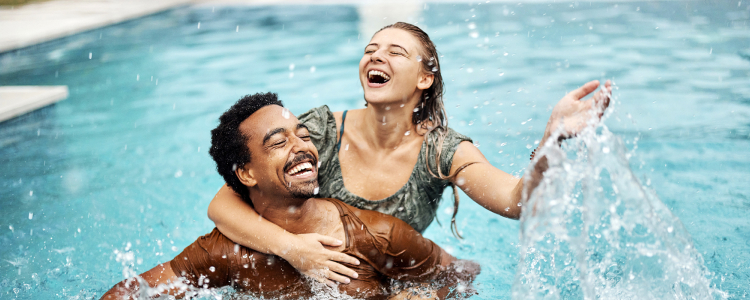 Young couple playing in the pool