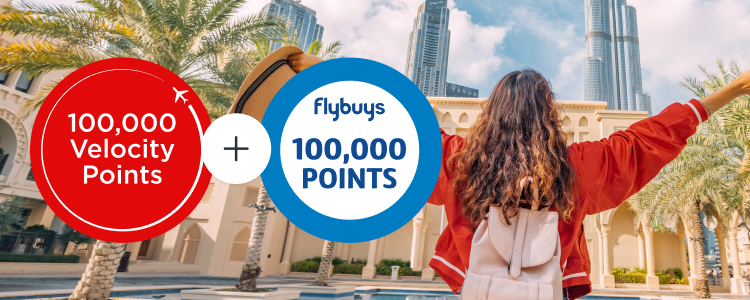 Excited female traveller with outstretched arms facing Burj Khalifa