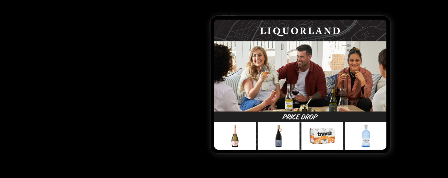 Friends enjoying a glass of wine on the couch and a selection of alcoholic beverages