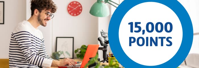 Unlimited 4G Home Internet for $59/month Man in striped shirt smiling at his laptop screen with 15,000 points text inside a circle