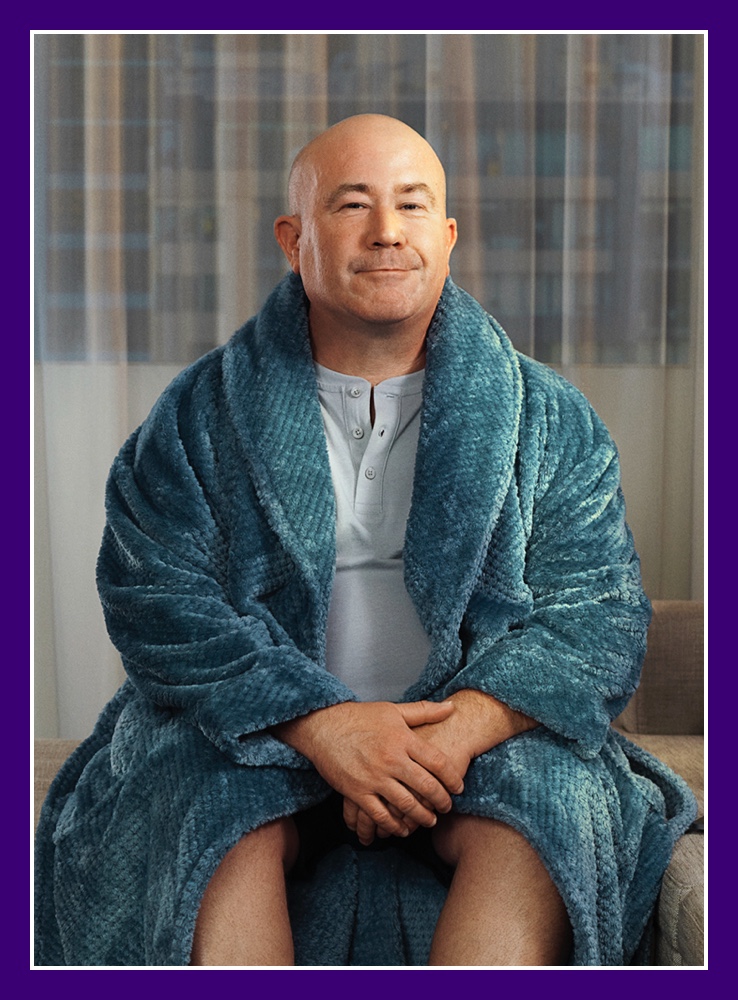 Flybuys' top 10 member Dale sitting on the couch in his bathrobe