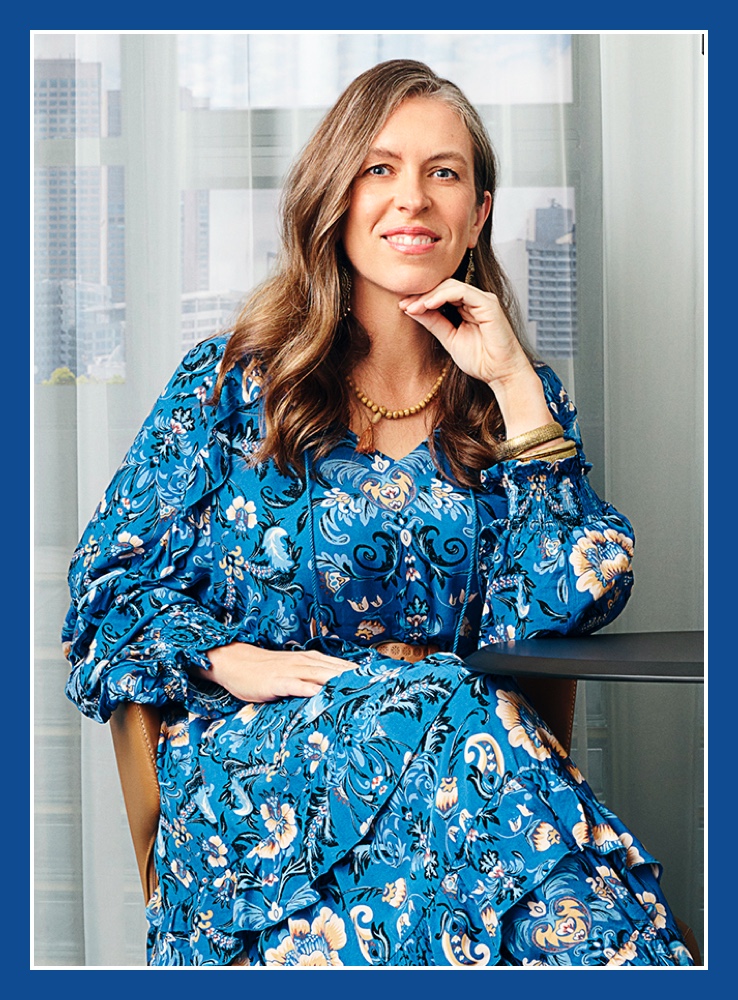 Flybuys' top 10 member Melanie smiling and sitting with chin resting on the back of her hand